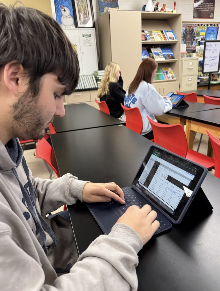 Junior Brandon Kroot checks the data shown from Yahoo Finance and inputs the numbers from his three stocks he chose into his project. In Mr. Clodfelter’s economics class students are choosing stocks and keeping track of the profit, loss, amount if sold and more through certain equations in a spreadsheet. “This project lets us understand the positive and the negative of future investments,” Kroot said. “It also shows why it is important to invest for the future, and teaches us the right ways to invest and grow wealth.”