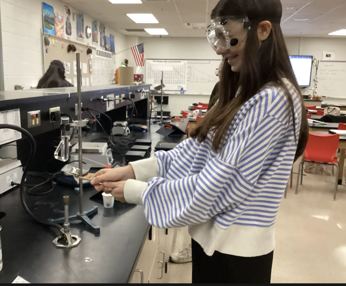 Using her striker, sophomore Sophia Counts lights her bunsen burner in teacher Alisha Milligan’s ACP chemistry class. With this experiment, students worked to see which bonds were stronger in either one tetracosane or one tetradecanol. “I learned that tetracosane has a higher melting point than tetrodeconal,” Counts said. “This was unexpected because a solid tetracosane is only held together with London dispersion forces, while tetradecanol has both London dispersion and hydrogen bonding.”