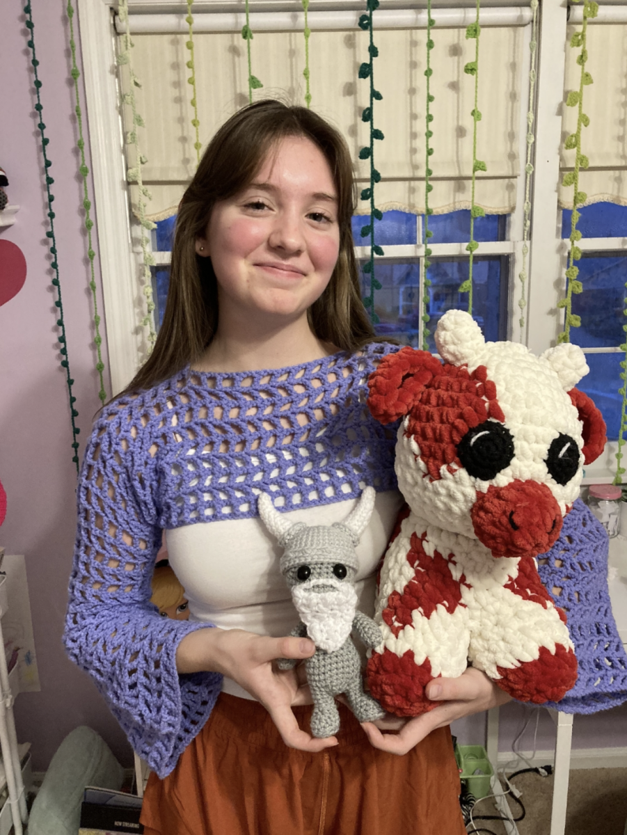 Sophomore Gina Hendel poses with items from her handmade crochet collection.