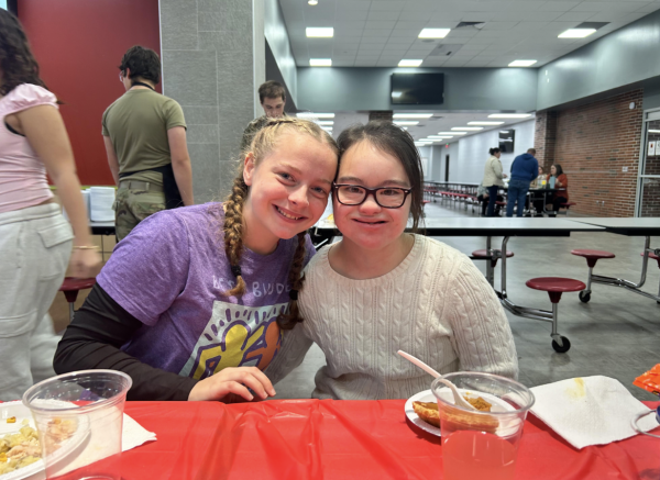 Freshman Ryleigh May poses for a photo with her buddy, junior Maggie Sims.