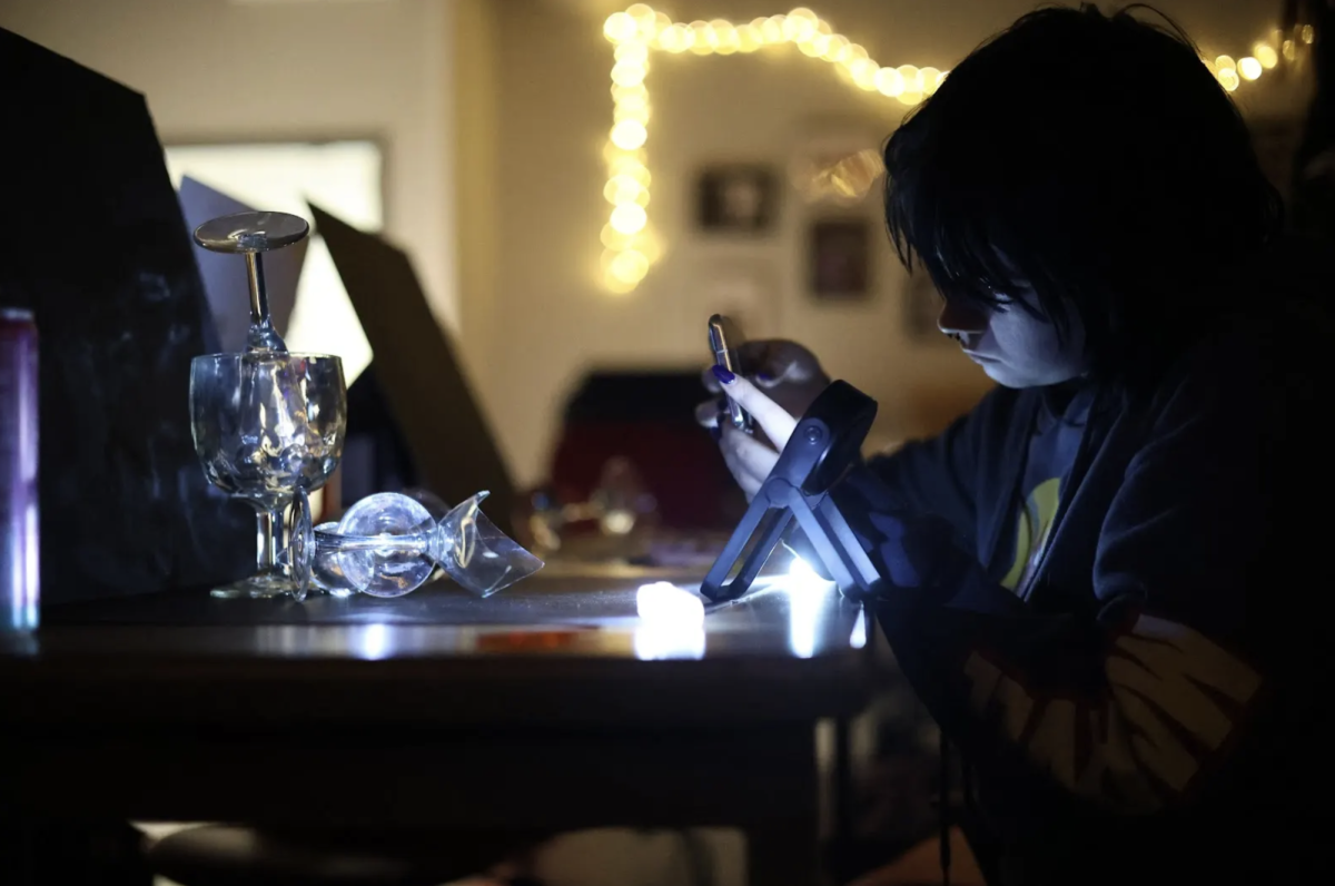 In Mrs. Fowler's first period photography class, Senior Jess Matula takes a photo of glass. Students in the class were using glass to help them learn how to frame and light the subject how the light can affect the subject to help with future photo rolls they have to take. "It's really interesting seeing how different lighting affects the glass and it's cool being able to compose the photo," Matula said. 