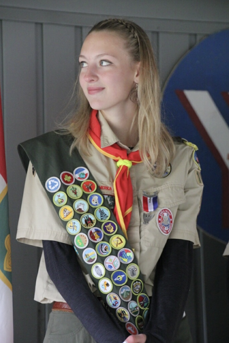 Rebecca Dillon stands on stage at her Court of Honor Ceremony