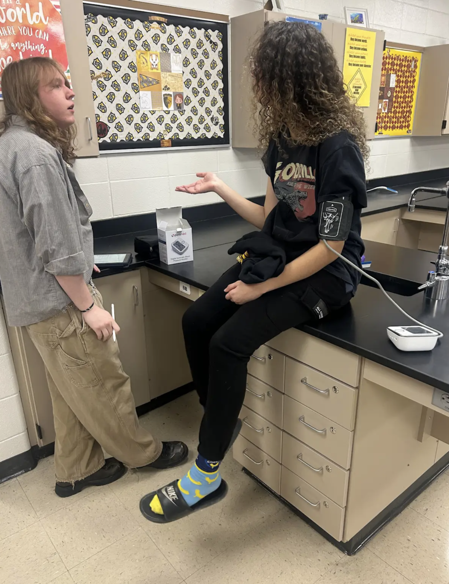 In order to learn about the cardiovascular system, Kairi Jackson ‘26 measures her blood pressure using a blood pressure cuff. This was a part of a lab in Mrs. Meyer’s anatomy class where students noted the difference between resting and active heart rate through activities like jogging, standing and lying down. “We were doing a cardiovascular fitness lab where we tested our heart rates and blood pressure,” Jackson said.