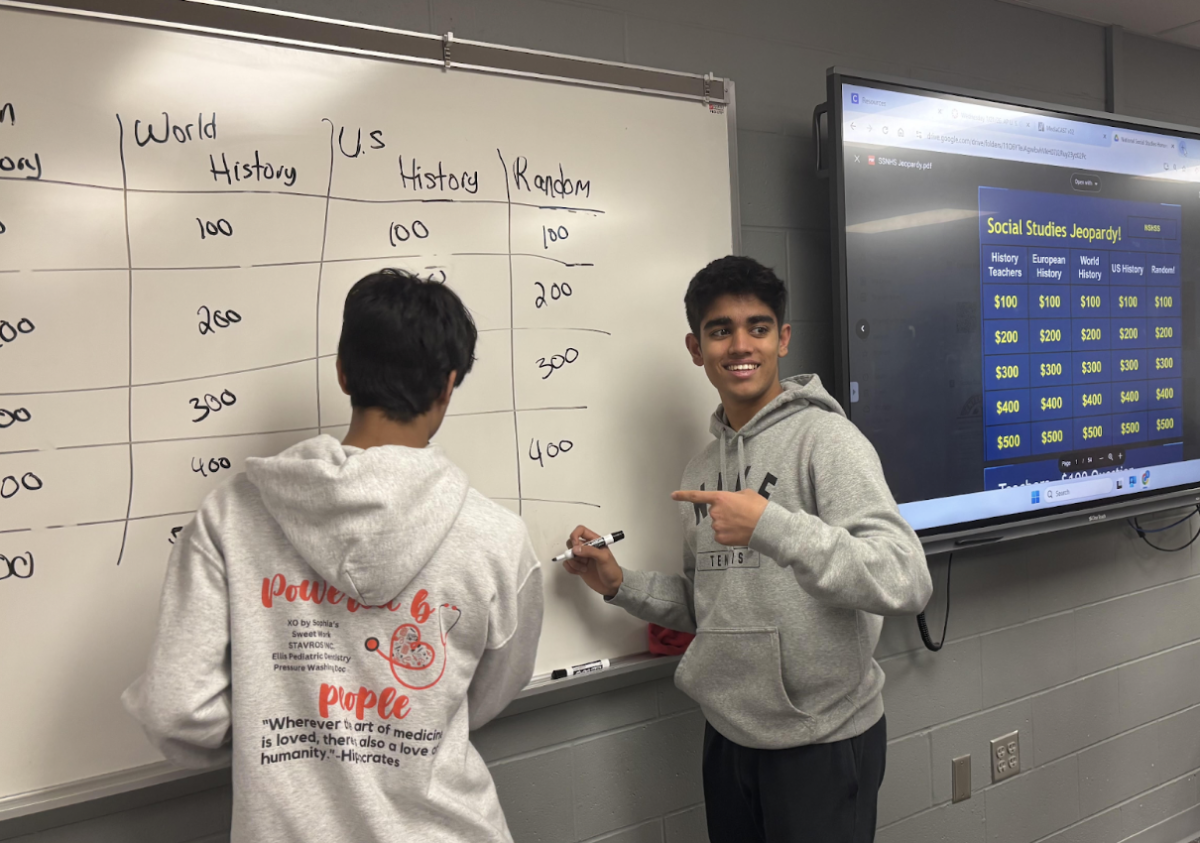 Juniors Chinmay Karyekar and Aryan Kapoor help keep score at the SSNHS meeting.