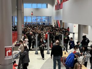 Students walk through metal detectors at the start of the school day on Friday, Feb. 6.