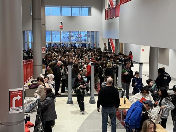 Students walk through metal detectors at the start of the school day on Friday, Feb. 6.