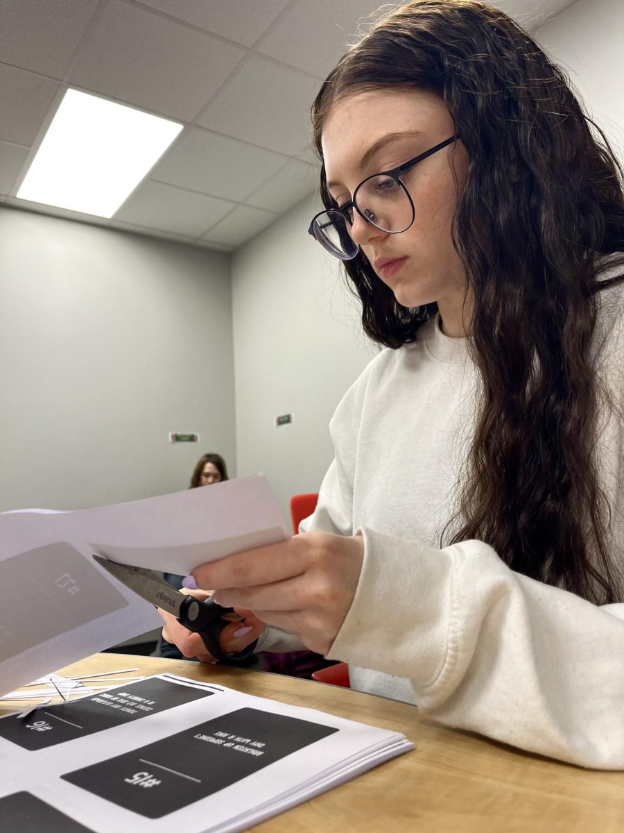Senior Bailey Rugenstein helps cut out positivity cards at a BC2M meeting. The club met on Wednesday during AIM to discuss upcoming events and future planned activities. "BC2M is about creating a space where people feel safe enough to talk honestly about what they're going through, and even small projects like this reflect our larger goal of building a more supportive community at school," Rugenstein said.