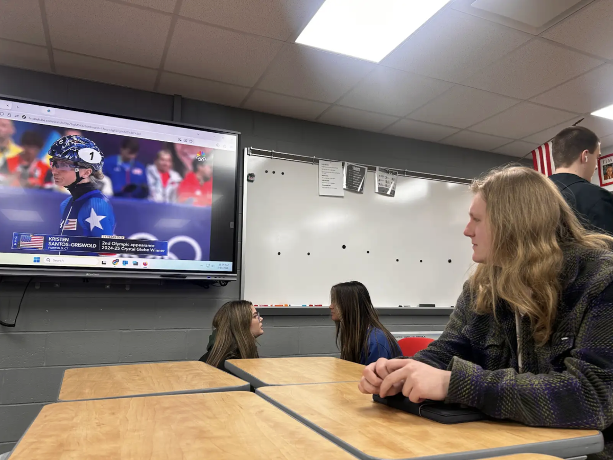 Senior Lucas Kappas watches the 2026 Winter Olympics in social studies teacher Cale Hoover's AP Government class. After students finished testing, Hoover played the Olympics so that students could keep up with the competition. "It was really interesting to watch sports which typically don't have a large following," Kappas said. "Especially regarding winter sports, the variety of athletes is insane and it's really fun to watch them compete."