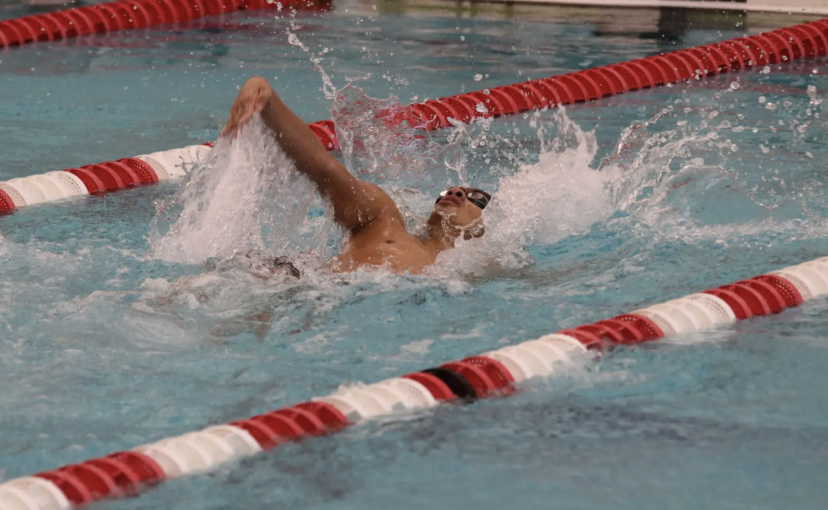 Finishing the 100 meter backstroke in the sectional finals, Junior Aksh Ranjan surges toward the wall on his final lap. Ranjan finished in 52.46 seconds, completing a sweep for the Trojans alongside teammates Henry Lyness and Moses Weaver. “Sharing the podium with my teammates meant a lot, because we push each other every day at practice,” Ranjan said. “Seeing that work translate into results at a big meet and being able to celebrate it together meant a lot to me.”