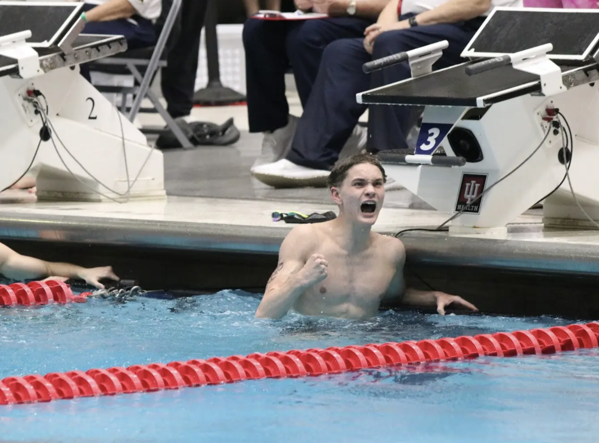 Hitting the wall after finishing the 200 yard freestyle in state prelims, Junior Moses Weaver celebrates after looking at the scoreboard. Weaver finished in a time of 1:40.93, which placed him in the A final where he finished 8th in finals. “This race was different because I really knew what I wanted out of it,” Weaver said. “I knew that my team was depending on me to make the top 8, so I really went out there and did it for them. Last year I didn’t even make it to state in this event, but making top 8 was an amazing feeling.”