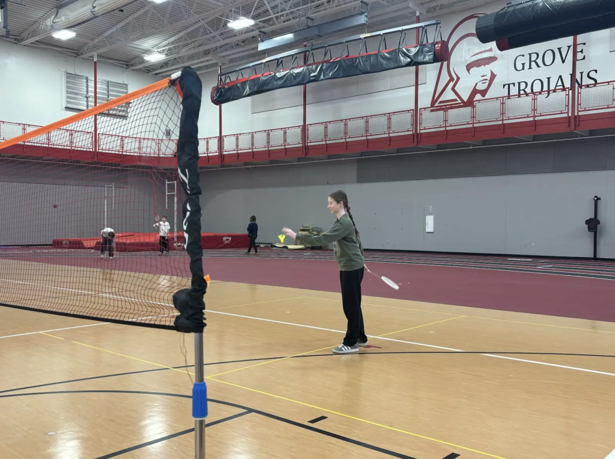 "In Coach Swain’s 10th period gym class, sophomore Parker Salrin goes to serve a birdie to her opponent. Salrin has been playing against sophomore Sage Hacker during class over the last couple weeks. “The birdie moves really differently than a normal ball, so you kind of have to adjust how you hit it,” Hacker said. “We’ve been playing badminton for a while now and it’s been really fun.”