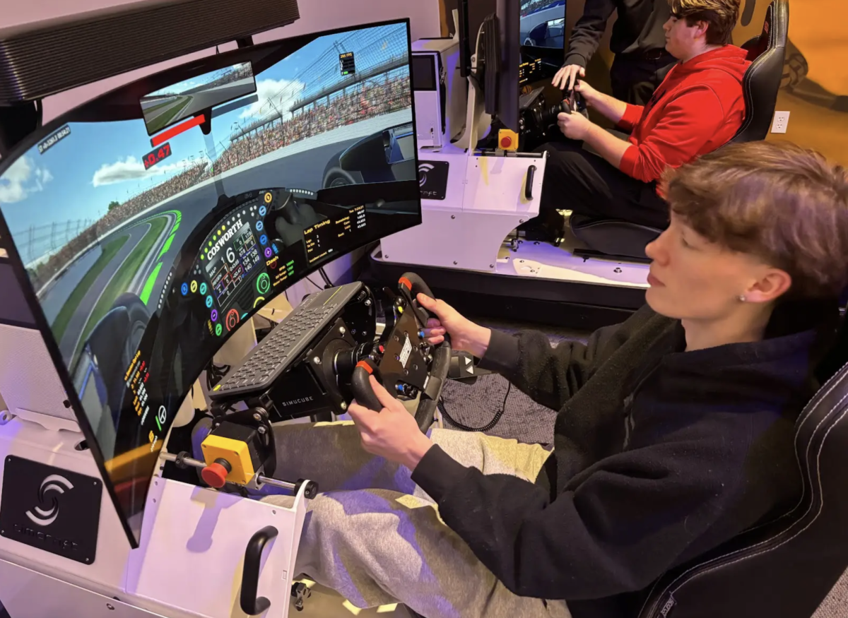 Competing in a driving simulator, senior Silas Falls controlls the wheel and pedals for a simulation at the Indianapolis Motor Speedway. This week, Debra Schoolcraft’s 5th period civil engineering class took a trip to the IMS to learn about the engineering that goes into keeping the track and everything included with that ready for the races held there. “I learned a lot, such as how race cars were made throughout the years and how the problems at the track are solved and fixed with engineers,” Falls said. “We got to tour the museum, suites and track. As well as this we had the vice president of construction management for the track, Tyrone Garrison, take us around and explain all of the though that goes into eveyrthing being perfect for the race days.”