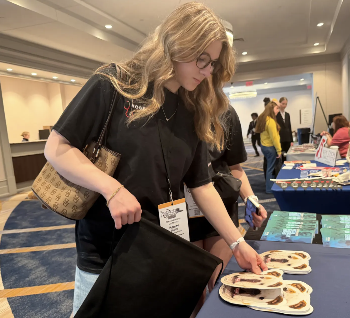 This week Hosa members attended their three day State Leadership Conference. On Thursday, there was a college fair open for all members to attend. Junior Keeley Shields, looks at pamphlets at the college fair for Butler University. Students get to talk to advisor’s of different colleges and talk about the different opportunities and majors. “I like the college fair because I get to learn about different programs and what they have to offer,” Shields said. “It is a good learning experience to actually meet with advisors of the schools and what the environment might be like at those schools.”