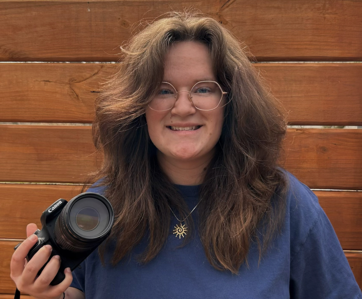 Junior Danielle Cooney poses with her camera 
